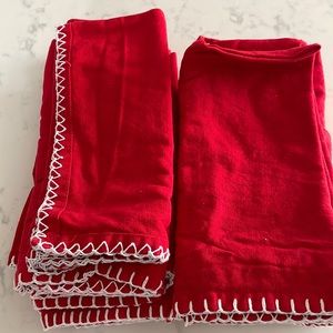 12 red cloth napkins with white stitching. Excellent condition!